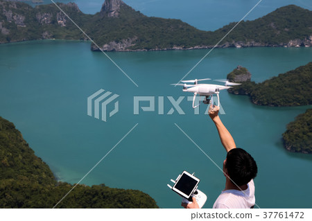 Hands holding a remote control and drone camera Hands holding a remote control and drone camera 37761472