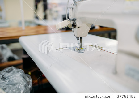 Sewing machine on clothing factory, nobody Sewing machine on clothing factory, nobody 37761495