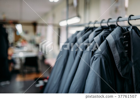 Row of jackets on hangers, clothing store, fabric 37761507