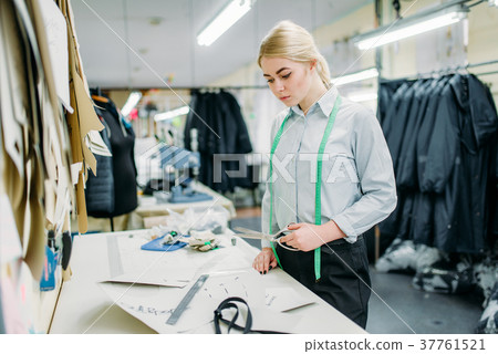 Clothes designer measures a pattern, sewing 37761521