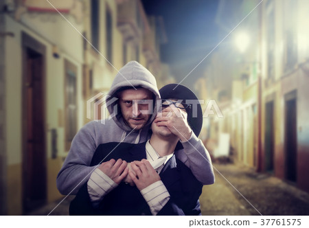 Thief with knife attack his victim on night street Thief with knife attack his victim on night street 37761575