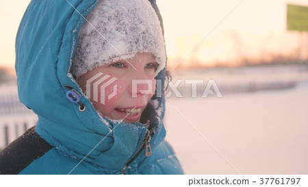A teenager in winter Park smiling face closeup A teenager in winter Park smiling face closeup 37761797