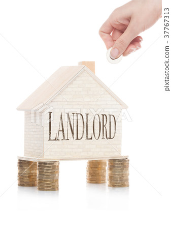 Wooden house model standing on coins and hand 37767313