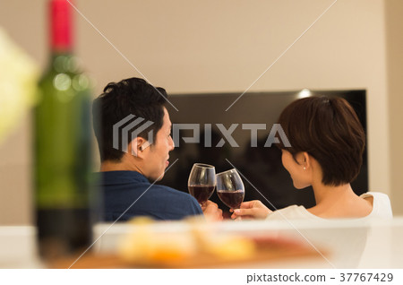 Middle couple relaxing on the sofa Middle couple relaxing on the sofa 37767429