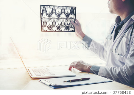 Doctor holding and checking chest x-ray film Doctor holding and checking chest x-ray film 37768438