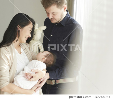 International marriage Married couple holding baby Portrait 37768984
