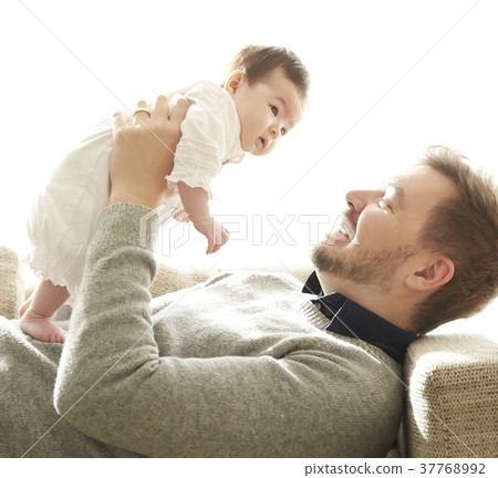 Dad hugging a baby 37768992