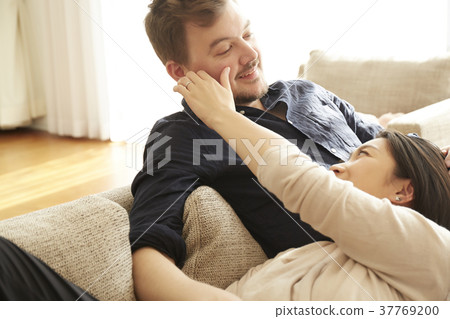 A relaxing couple in the living room 37769200
