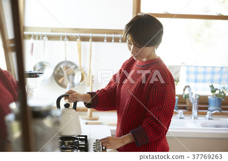 A woman in the kitchen A woman in the kitchen 37769263