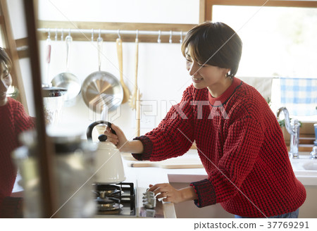 A woman in the kitchen A woman in the kitchen 37769291