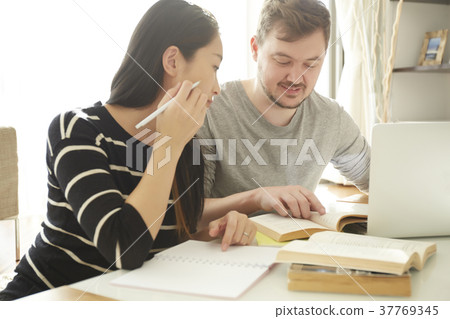 Woman who learns English conversation with foreign lecturer Woman who learns English conversation with foreign lecturer 37769345