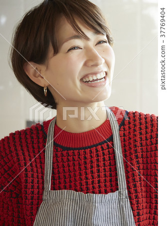 A woman in the kitchen A woman in the kitchen 37769404