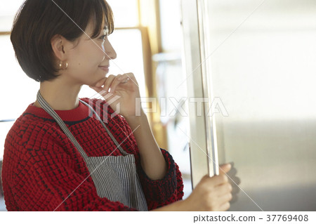 A woman in the kitchen A woman in the kitchen 37769408