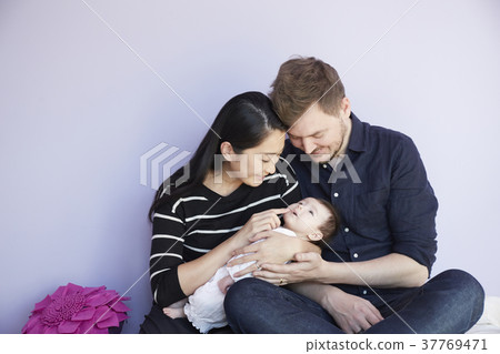 Parents loving baby in a children's room 37769471