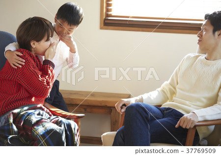 A family relaxing in the living room A family relaxing in the living room 37769509