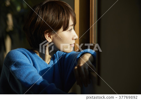 Woman relaxing in the living room Woman relaxing in the living room 37769892