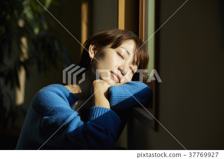 Woman relaxing in the living room Woman relaxing in the living room 37769927