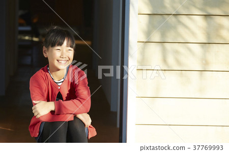 Girl sitting at the entrance 37769993