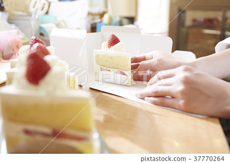 Hand boxing in a cake shop Hand boxing in a cake shop 37770264