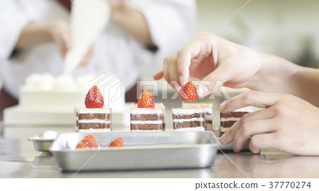 Person making cake in cake shop 37770274