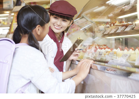 Woman doing part-time job at a cake shop 37770425