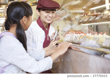 Woman doing part-time job at a cake shop Woman doing part-time job at a cake shop 37770433
