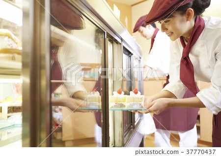 Woman doing part-time job at a cake shop 37770437