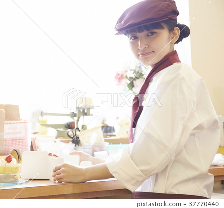 Woman doing part-time job at a cake shop 37770440