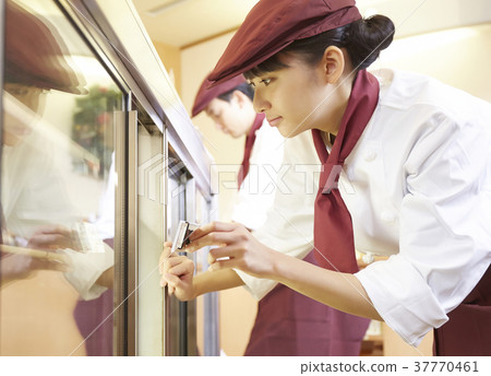 Woman doing part-time job at a cake shop 37770461