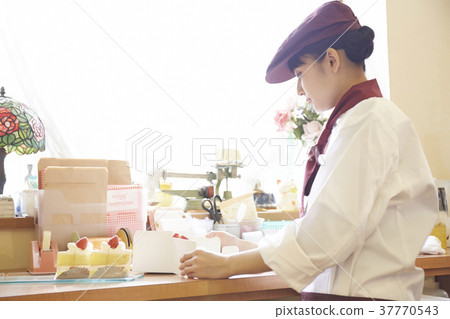 Woman doing part-time job at a cake shop Woman doing part-time job at a cake shop 37770543