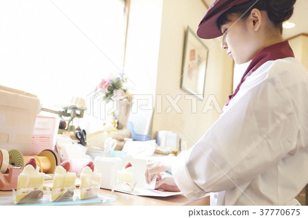 Woman doing part-time job at a cake shop 37770675