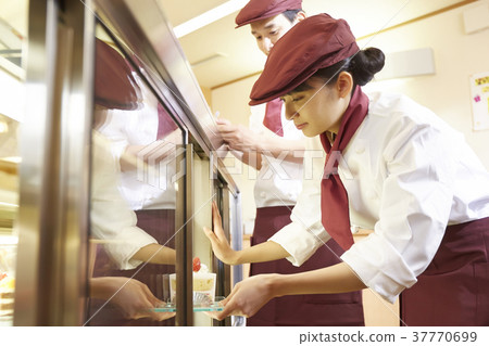 Woman doing part-time job at a cake shop 37770699