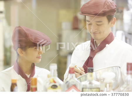 Men and women working in a cake shop Men and women working in a cake shop 37770830
