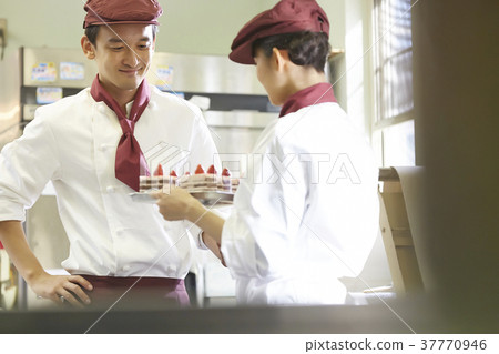 Men and women working in a cake shop Men and women working in a cake shop 37770946