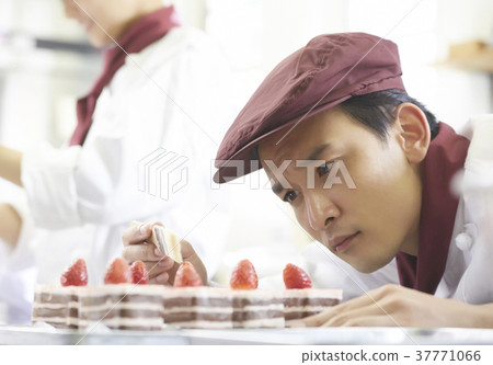 Men working in a cake shop Men working in a cake shop 37771066