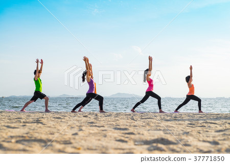 Yoga class at sea beach in sunset time 37771850