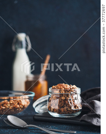 Homemade granola in glass jar on dark table 37772697