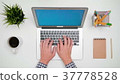 A Man's Hands Typing on the Laptop 37778528