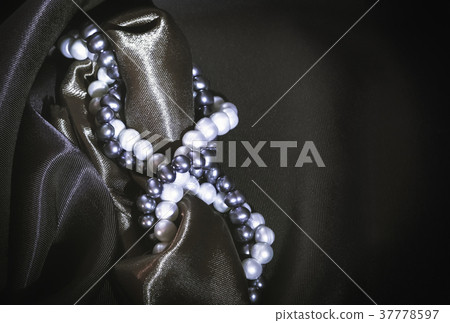 Natural Pearl Necklaces On A Dark Silk Background Natural Pearl Necklaces On A Dark Silk Background 37778597