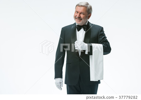 Senior waiter holding white towel Senior waiter holding white towel 37779282