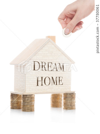 Wooden house model standing on coins and hand 37780061