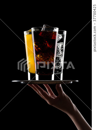 Hand holds tray with glass of cola orange water Hand holds tray with glass of cola orange water 37780425