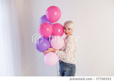 blonde girl with balloons and gifts for holiday 37780583