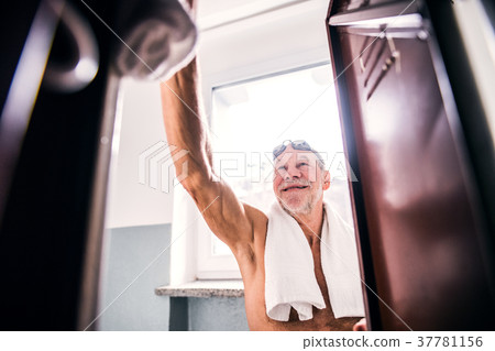 Senior man by the lockers in an indoor swimming 37781156