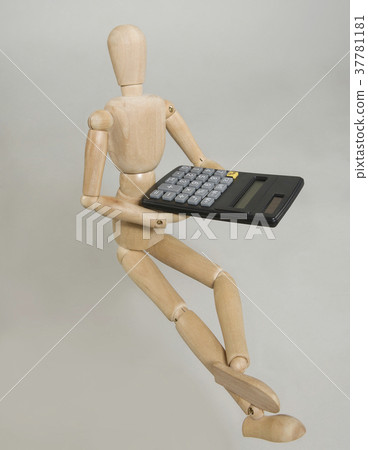 a puppet with a calculator on a gray background 37781181