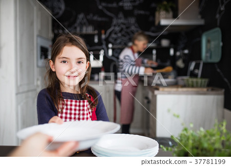 A small girl with mother and grandmother at home. 37781199
