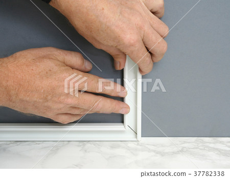 Handyman installing surface mount channel Handyman installing surface mount channel 37782338