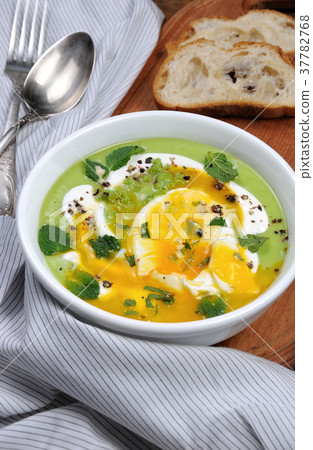 Pea puree soup with poached egg and peppermint Pea puree soup with poached egg and peppermint 37782768