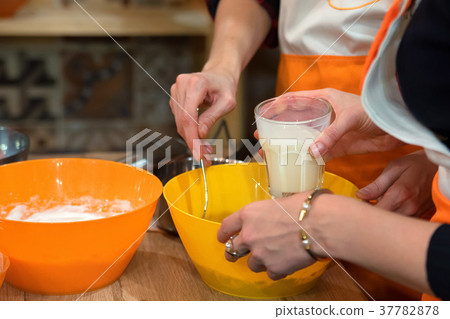 Female hands mix ingredients for dough 37782878