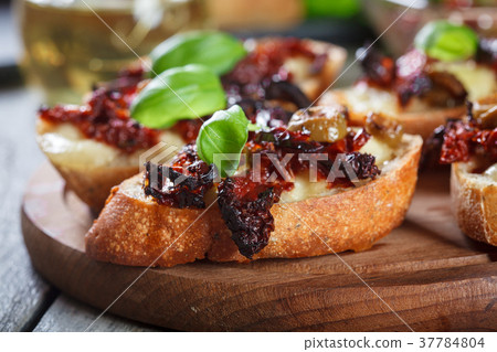 Appetizer bruschetta with sun-dried tomatoes Appetizer bruschetta with sun-dried tomatoes 37784804